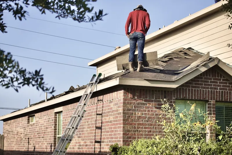 Professional roofer working on a residential roof in Galewood